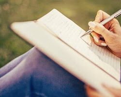 person writing in a gratitude journal