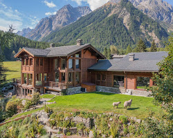 Person reading book in chalet by fire in Swiss Alps