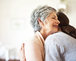 group of people hugging, showing compassion