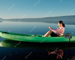person sitting by a river, enjoying the scenery