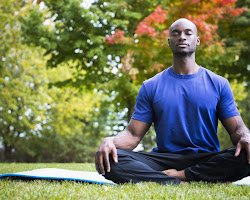 person sitting in a comfortable position, meditating