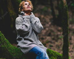 person sitting in a forest, feeling connected to nature