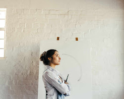 young artist looking at a blank canvas