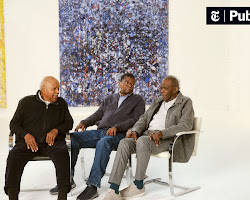 young artist talking to an older artist in a studio