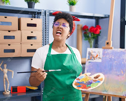 young artist working in their studio, looking frustrated